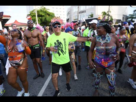 Bacchanal Jamaica’s Michael Ammar (centre) was spotted chipping with revellers.