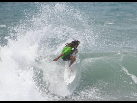 Elishama Beckford pulls off one of his manoeuvres during the Jamaica Surfing Association National Open Series competition at Lighthouse Beach, Kingston. 