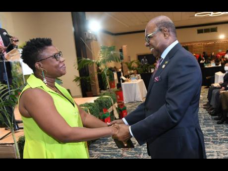 Edmund Bartlett, minister of tourism, greets Lashawnda Bailey Miller, creative director of Inzzpire365, at the eighth staging of the Christmas in July trade show at  The Jamaica Pegasus hotel on Tuesday.