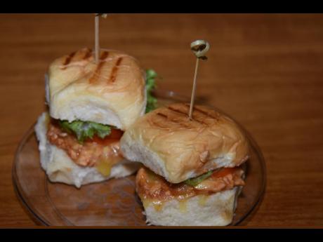 Barbecued chicken sliders on toasted buns. 
