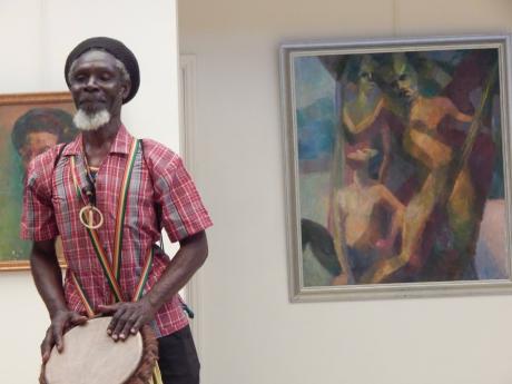 Master drummer Calvin Mitchell provided background music at the book launch and painting exhibition. 