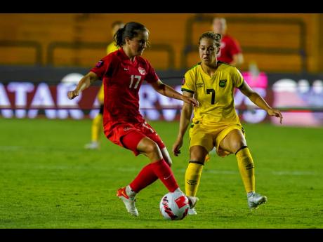 Canada's Jessie Fleming (left) and Jamaica's Chinyelu Asher compete for the ball during their Concacaf  Women's Championship  semi-final match in Monterrey, Mexico on Thursday night. 