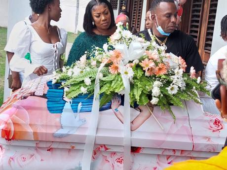 Richard Dean, father of the late Shanice Dean, gathers with other mourners in front of the coffin bearing her remains at Thursday’s funeral at Good Tidings Mennonite Church on Whitehall Avenue, St Andrew.