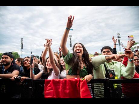 Festivalgoers are seen during the Festival d'été de Québec on Thursday July 14, 2022, in Quebec City. (Photo by Amy Harris/Invision/AP)