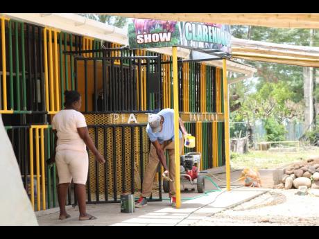 Members of the Clarendon Association of Branch Societies of the Jamaica Agricultural Society busy sprucing up their pavilion as they prepare for the Denbigh Agricultural, Industrial and Food Show slated for July 30-August 1.