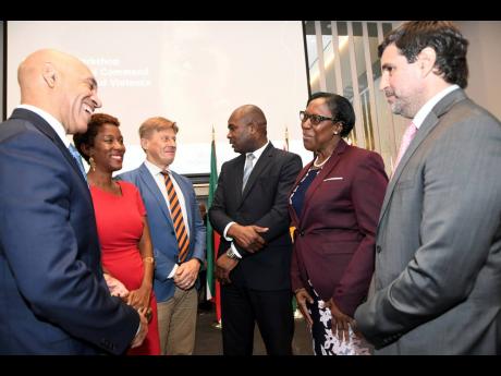 State Minister in the Ministry of National Security, Zavia Mayne (third right), converses with Fredrik Ekfeldt, deputy head of delegation for the European Union to Jamaica, at the regional workshop on operational command of gender-based violence policing i