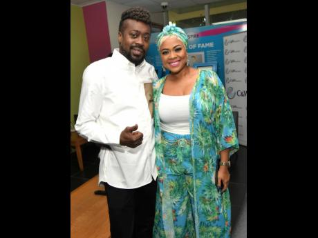 Beenie Man (left), poses with Debbie Bissoon at Flow’s Sum-Summa Breakfast Party last Friday.