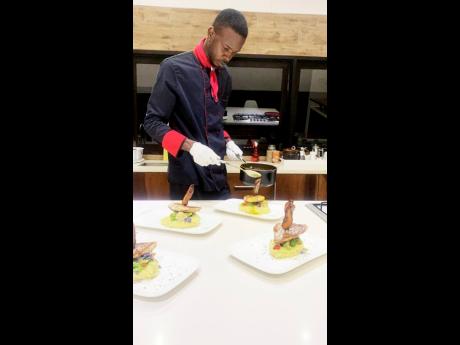 Chef Lindo in his element, adding final touches to one of his signature dishes. 