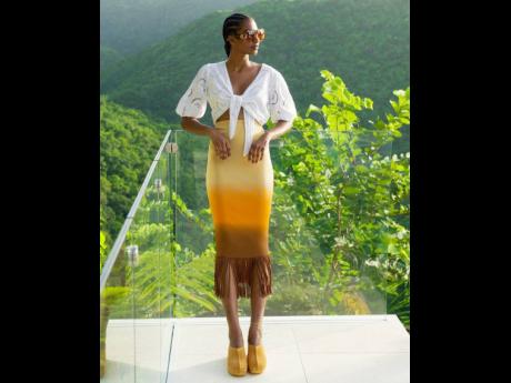 Portland-born beauty Tash Ogeare, winner of SAINT’s 2018 female Fashion Face of the Caribbean, in a Sandro midi skirt with fringed hemline, Guess eyelet top, Longchamp sunglasses and River Island clogs.