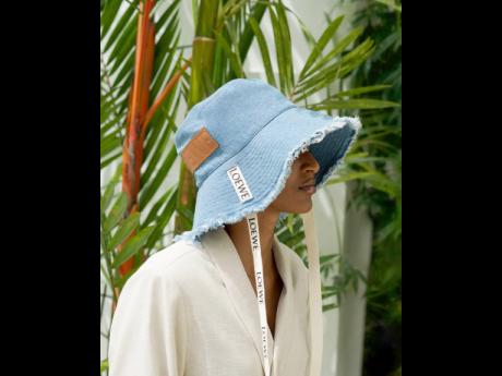 Tash Ogeare is cool for the summer in a John Lewis jacket and a Loewe frayed fisherman hat in denim and calfskin.