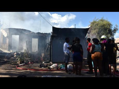 Some 12 persons were left homeless after a fire destroyed a house on Norman Crescent in Kingston yesterday. 