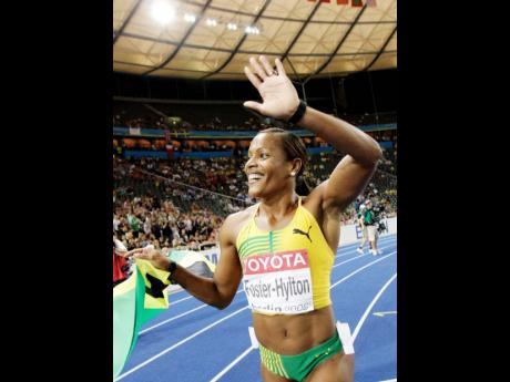 Brigitte Foster-Hylton celebrates after winning gold in the 100-metre hurdles at the World Championships in Berlin, Germany, in 2009.