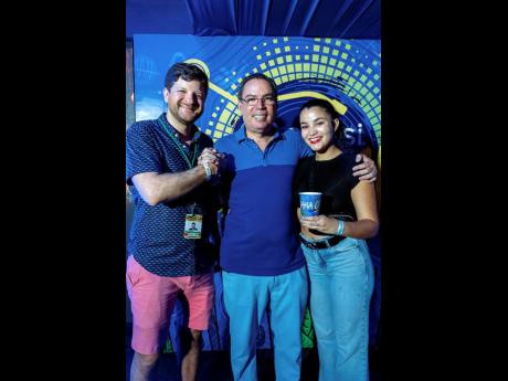 Jose Romero (left), commercial manager at Pepsi-Cola Jamaica, poses for a photo with Daryl Vaz, minister of science, energy and technology, and his daughter, Victoria Vaz, at the Pepsi booth.