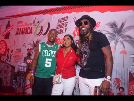 From left: ‘Top Boy’ star Michael Ward, Red Stripe Trade Marketing Manager Anjelica Holmes, and entertainer and legendary cricketer, Chris Gayle, share lens time in the Red Stripe Vibes Lounge on night one of Reggae Sumfest. 