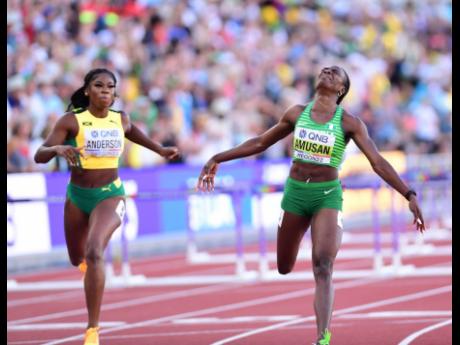 Jamaica’s Britany Anderson (left) crossing the finish line to take silver in the women’s 100 metres hurdles final at the 2022 World Championships in Eugene, Oregon last night. The event was won by world record holder Tobi Amusan of  Nigeria (right) in 