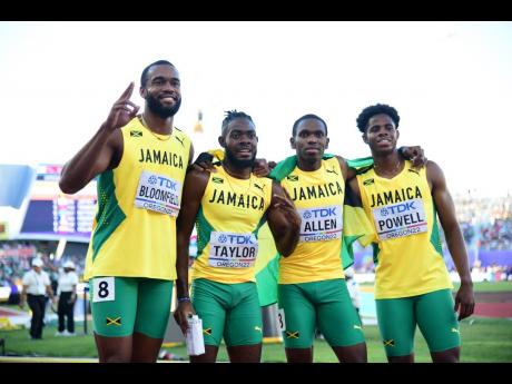 Jamaica’s men celebrate after claiming second place and silver medals in the 4x400 metres men’s final at the World Athletics Championships yesterday. From left: Akeem Bloomfield, Christopher Taylor, Nathon Allen and Jevaughn Powell.