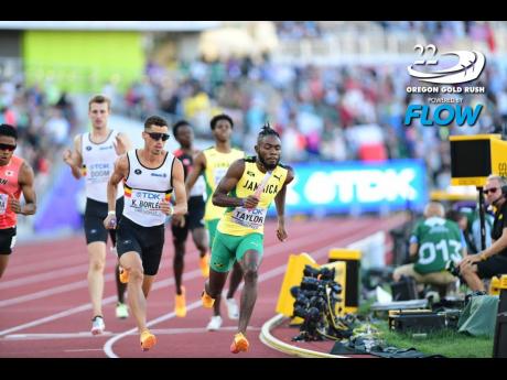 Jamaica’s Christopher Taylor (right) on the final leg of the men’s  4x400 metres relay in Eugene, Oregon yesterday. 
