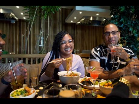 Social media influencers Britney Gooden (left) and Quite Perry having a conversation over poke bowls and cocktails. 