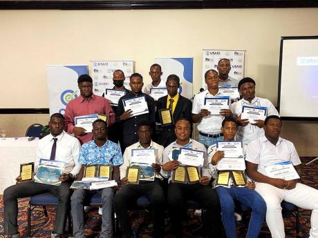 Graduates of the Technical Skills Training Transformation and Empowerment Project (T-STTEP) pose with their certificates and awards.