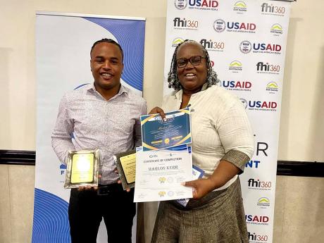 Marlon Kerr (left) with his mentor, Annette Irving, shows off his course certificate of completion and award  for being the Most Improved Participant under the Technical Skills Training Transformation and Empowerment Project.  