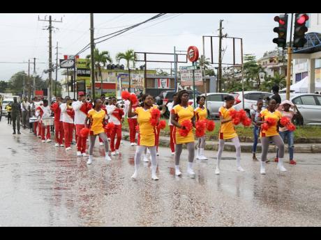 The afternoon rain in Mandeville, Manchester, was not enough to stop the Jamaica 60 float parade which went across the parish on Thursday.