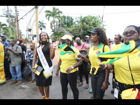 Jamaica Festival Queen 2021 Dominque Reid, who was crowned Miss Manchester Festival Queen in June last year, waves as she passes by with members of the Manchester Lay Magistrates Association.
