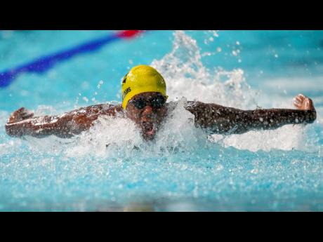 Sidrell Williams of Jamaica swims in his men's 100m butterfly heat at the Commonwealth Games inside the Sandwell Aquatics Centre in Birmingham, England on Monday.