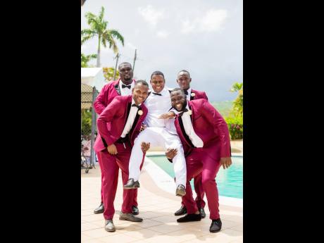 No longer a bachelor, the groomsmen were happy to support their brother in life on his wedding day. From left: (back row) Ruel Hamilton and Fabian Prince, along with (front row) Danardo Ellis and Conrod Roberts carry their groom to victory.