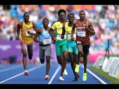Kenya’s Cornelius Tuwei (right) leads a men’s 800m round one heat on day six of the Birmingham 2022 Commonwealth Games at Alexander Stadium yesterday in Birmingham, England. Jamaica’s Navasky Anderson (third right) is comfortable in pursuit.