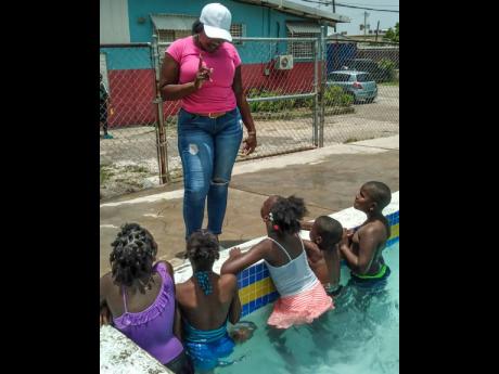 Summer school students get tips on swimming.