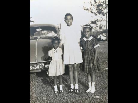 Topaz Kirlew (left) stands beside her sisters, Mary, the oldest, and Therese.