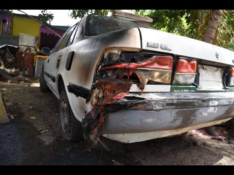 A car that was partially damaged in Mexico, Gregory Park, in firebombing attacks.