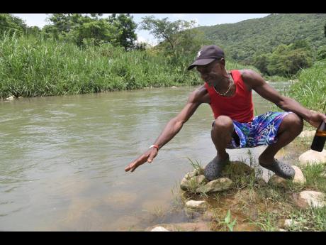 Paul Weir, a fisherman from Kent Village near Bog Walk, St Catherine, contemplates his next move days after a fish kill in the Rio Cobre. A chemical spill on the weekend has put a pause on the livelihood of fisherfolk and disrupted water supply provided by
