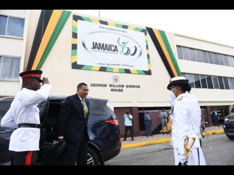 Prime Minister Andrew Holness is greeted by Rear Admiral Antonette Wemyss Gorman, chief of defence staff of the Jamaica Defence Force, on his arrival at Gordon House yesterday for a special joint sitting of Parliament on the eve of the island’s celebrati