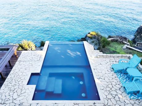 An infinity-edge spa plunge pool fills the backyard. 