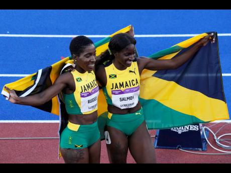 
Gold medallist Janieve Russell (left) and silver medallist Shiann Salmon, both of Jamaica, celebrate at the end of the women’s 400-metre hurdles during the athletics competition in the Alexander Stadium at the Commonwealth Games in Birmingham, England y