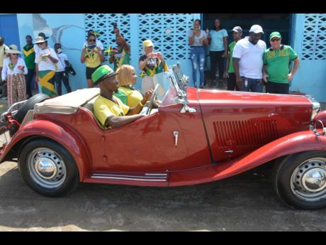 A vintage MG arrives for the Independence Day float parade in Treasure Beach on Saturday.