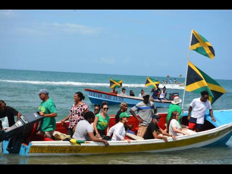 Right: Locals and visitors aboard vessels in the 60-flag boat parade on Independence Day in Treasure Beach, St Elizabeth, on August 6.