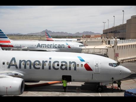 American Airlines aircraft wait at gates at Phoenix Sky Harbor International Airport in Phoenix, on June 7, 2021.