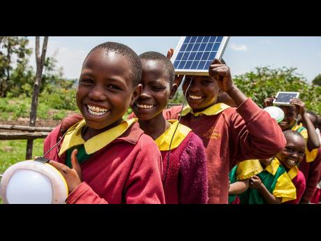 Children in Mali, West Africa whose lives are being improved with solar-powered devices. Global cooperation is needed to help improve the lives of people living in extreme poverty.
