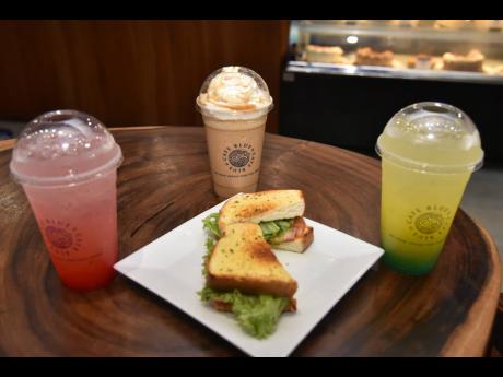 Cafe Blue presents the stars of their Summer Bite show, black forest ham sandwich, surrounded by Summer Bliss sensations mango fizz, lychee blush and salted caramel frappuccino. 