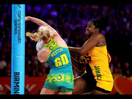 Above: Jamaica’s captain and goal shooter Jhaniele Fowler (right) tussles for the 
ball with Australia’s goal defence Jo Weston 
during the Commonwealth Games netball final at the NEC Arena in Birmingham, England, on Sunday. 