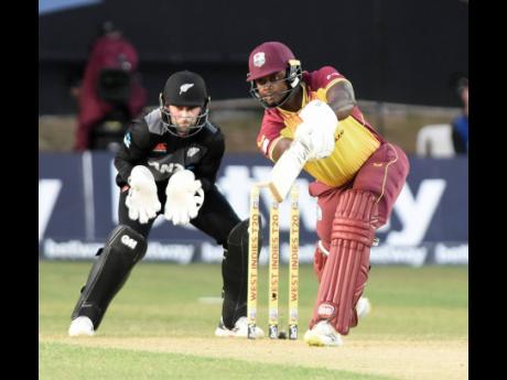 West Indies allrounder Romario Shepherd (right) plays one of his many lusty blows on his way to 31 from 16 balls during the first T20 International of a three-match series against New Zealand at Sabina Park. Looking on is New Zealand wicketkeeper Devon Con