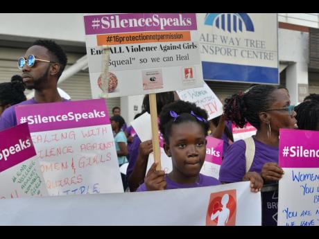 Advocacy groups staged a peaceful protest against gender-based violence at the Half-Way Tree Transport Centre earlier this year. 