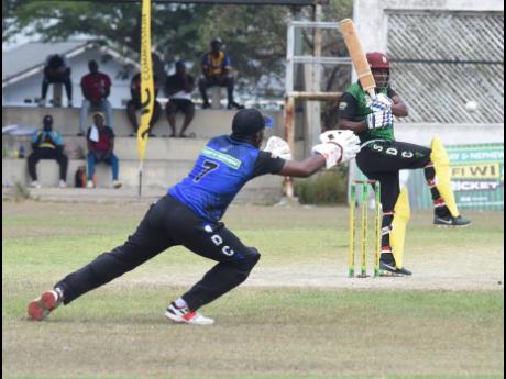 Boscobel’s wicketkeeper Maurice Harrow (left) fails to catch the ball from a pull shot by Krishmar Santokie (right) of  Racecourse during the quarter-finals of the SDC/Wray and Nephew National Community Twenty20 Cricket Competition at Chedwin Park in St 