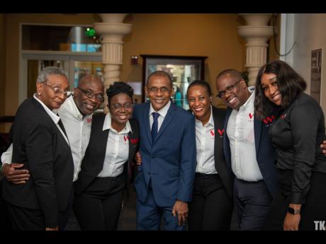 The VM Group team huddles at the Jamaican Emancipendence Awards Ceremony. From left are: Gracelin Williams, Beresford Nelson, Calene Grossett, Courtney Campbell, Suzette Rochester Lloyd, Leighton Smith, and Peter-Gaye Russell-Peart.