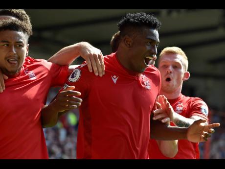 Nottingham Forest’s Taiwo Awoniyi (centre) celebrates with his teammates after scoring against West Ham during their English Premier League match at the City ground in Nottingham, England yesterday.