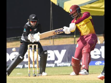 Inset: West Indies batsman Brandon King (right) during his attacking 53 in the third  T20 International cricket match against New Zealand at Sabina Park  yesterday. The wicketkeeper is Devon Conway. King hit four fours and three sixes as he posted an enter