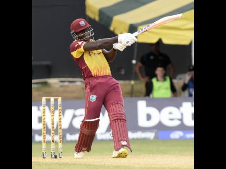 Captain Rovman Powell hits a boundary during his unbeaten 27 against New Zealand at Sabina Park yesterday. West Indies defeated New Zealand by eight wickets in the final T20 International.
