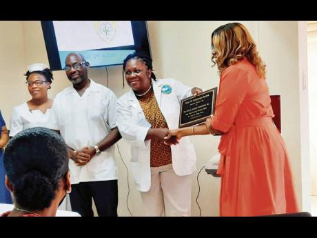 Aj Stone, team leader of the AJA St Ann & St Mary, presents a plaque to Dr Tanya Hamilton-Johnson.
Also in photo are other members of the maternity ward at the St Ann’s Bay Regional Hospital From left: Nurse Grace Ann Gordon-Johnson and Dr Patrick Clarke